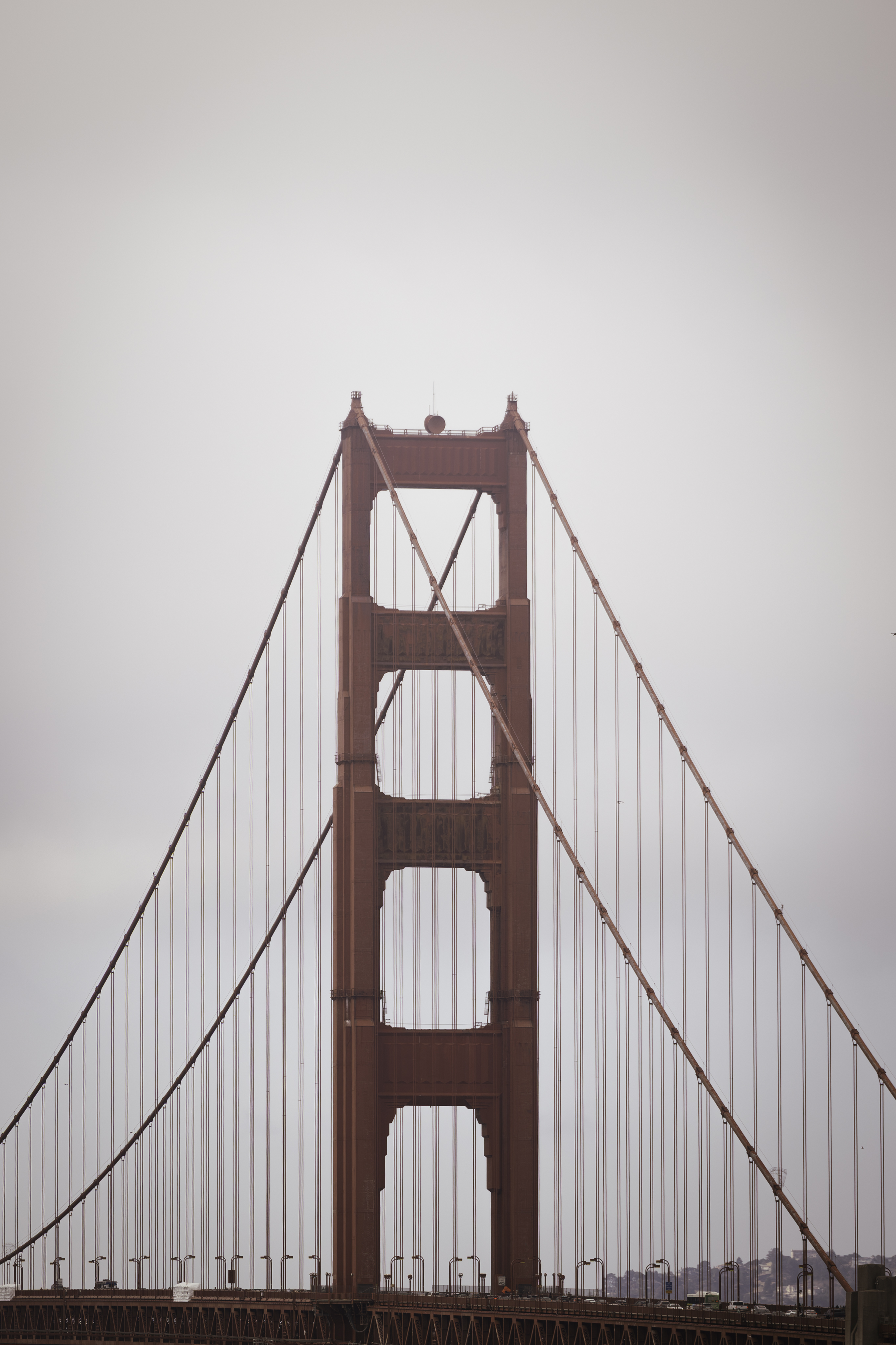 Golden Gate Bridge tower in fog, overcast sky, San Francisco